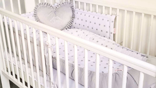 cot bed size 70x140 in white with baby sleeping pod nest in large size cot bumper with little stars and velvet heart pillow with embroidery rocking horse