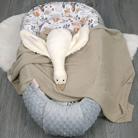 Lifestyle photo of woodland baby nest in nursery – cosy soothing sleep accessory for babies bamboo blanket and plush goose comforter