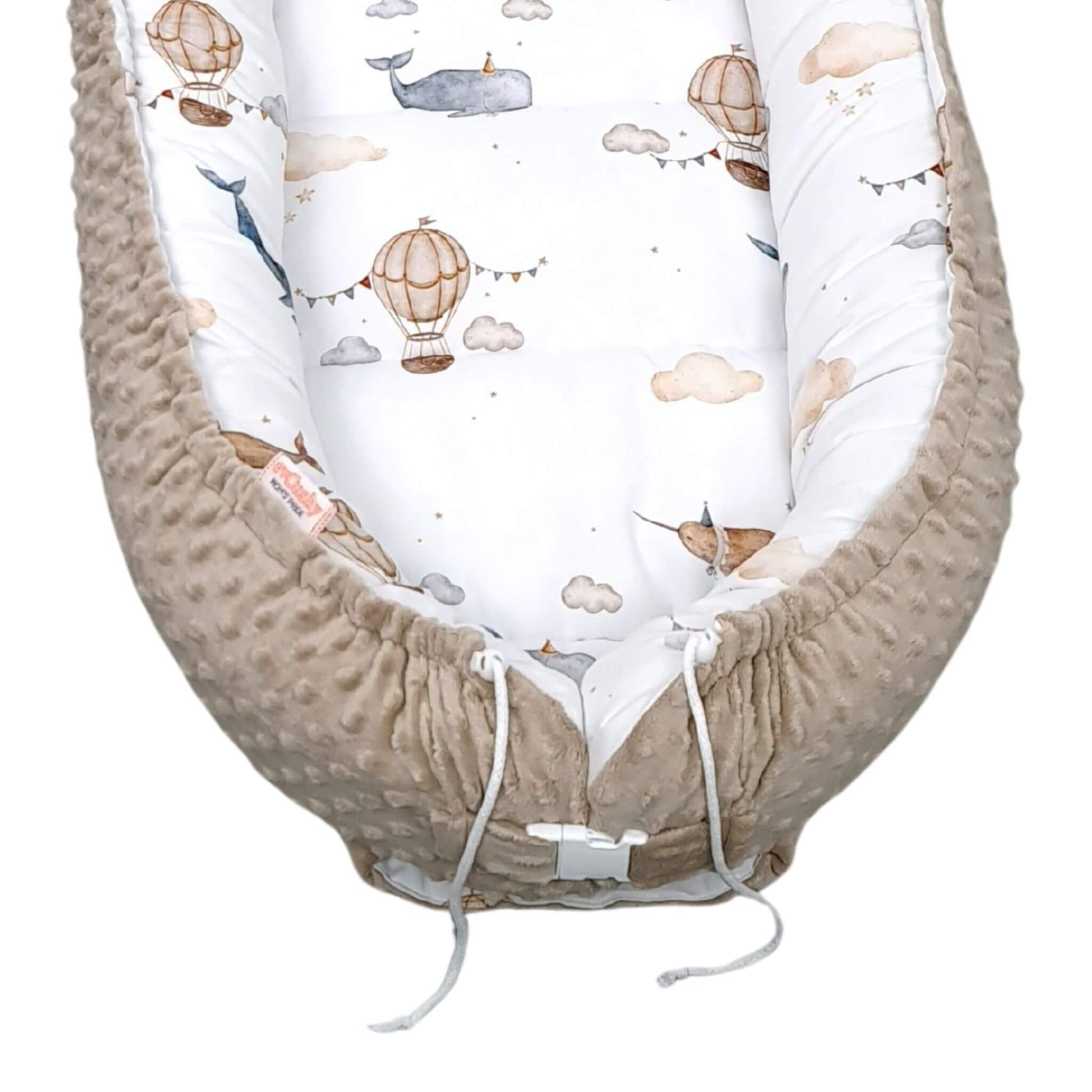 Close-up of mocha plush base and sky-themed fabric of baby lounger