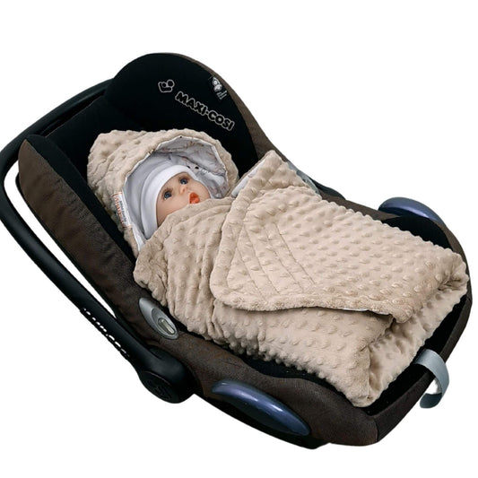 Baby in a car seat with a beige blanket and hat, Maxi-Cosi brand visible Baby wrapped in Evcushy Retro Bunny Blanket with taupe minky plush in car seat