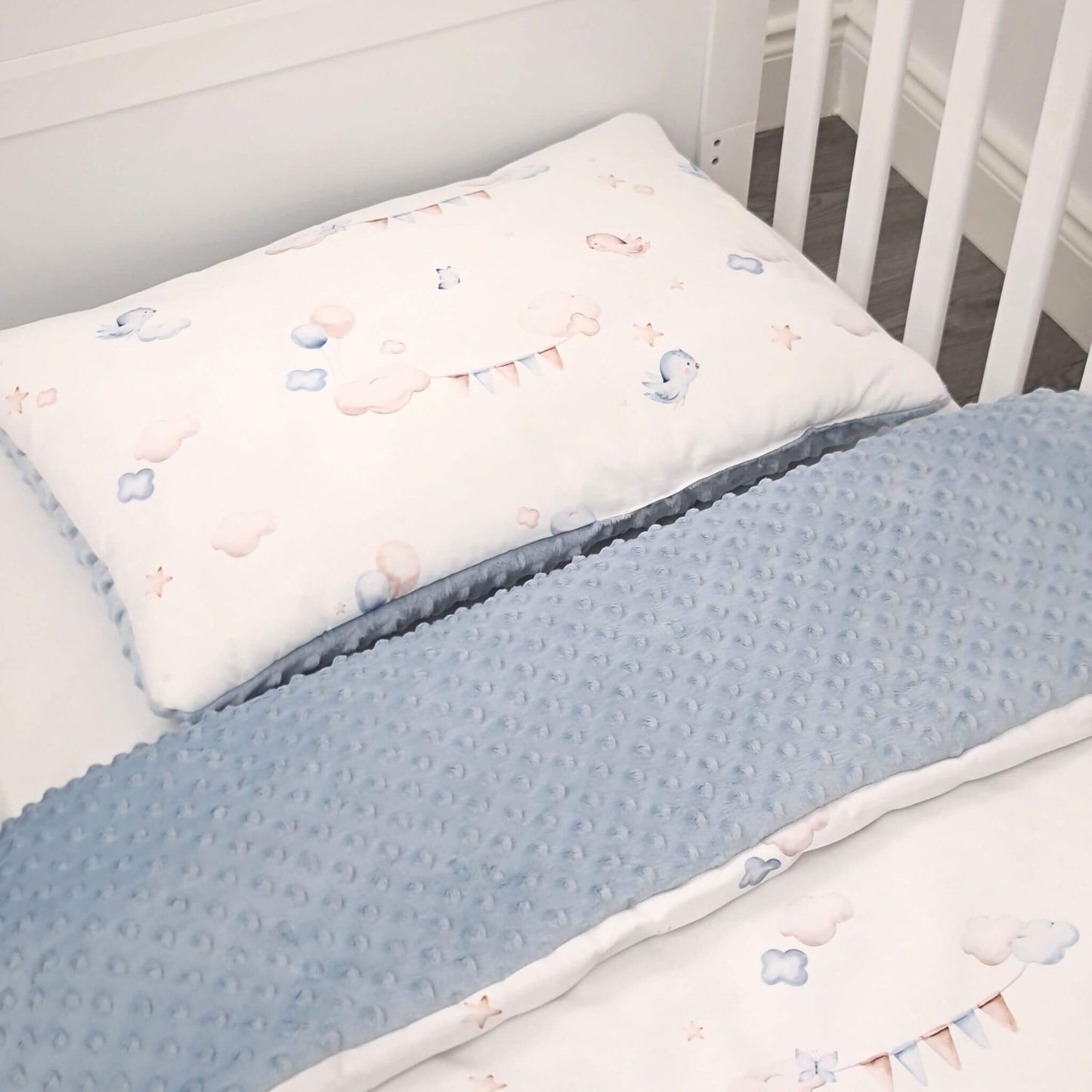 Close-up of Up in the Sky quilt and pillow made from 100% breathable cotton and blue plush