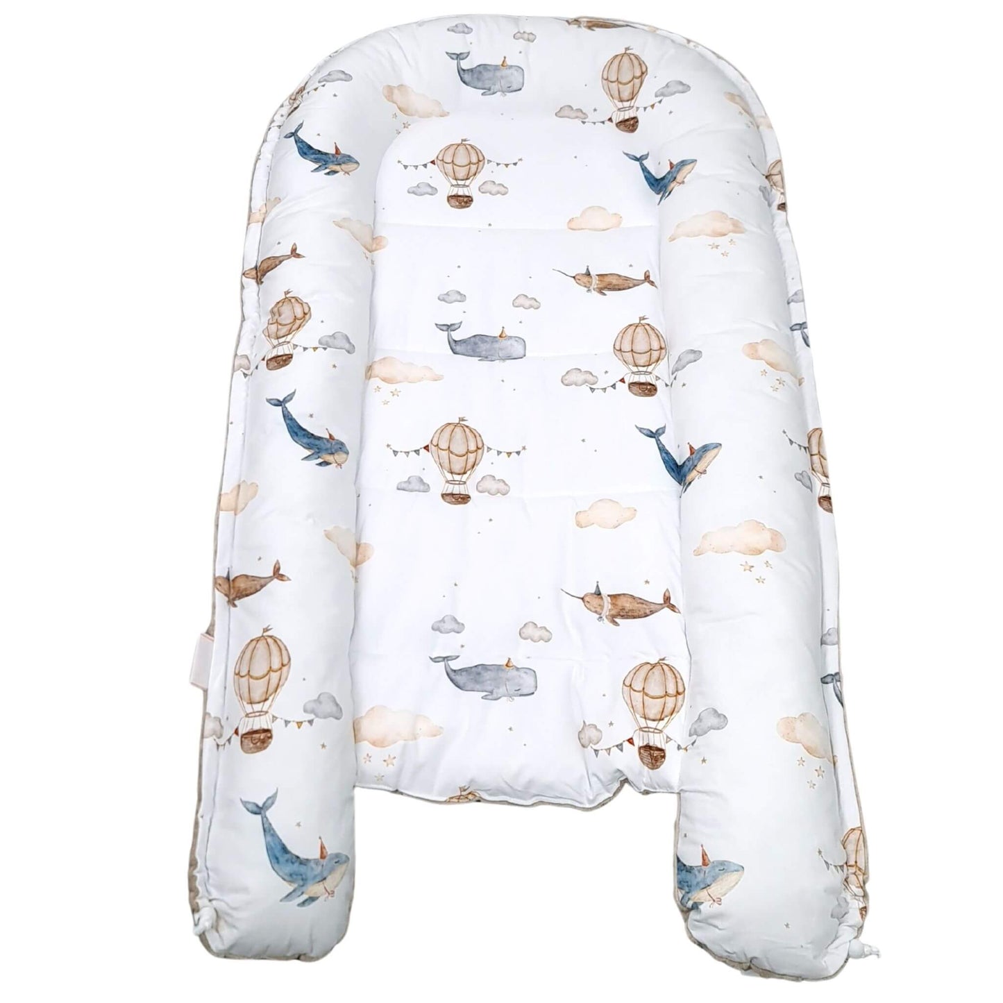 Top view of Mocha Mousse bottom baby nest with whale and balloon pattern play mat for toddler