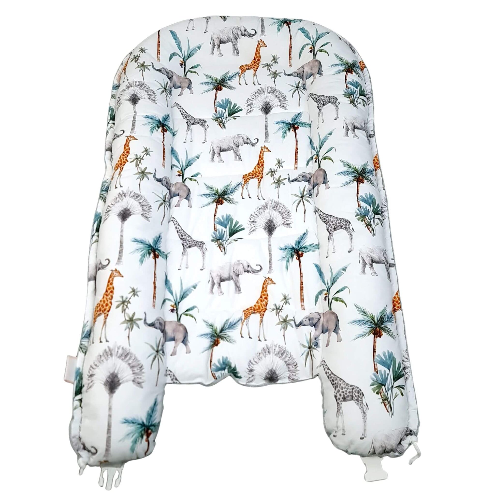 Flat lay of safari pattern toddler nest showing elephants, giraffes and palm leaves.