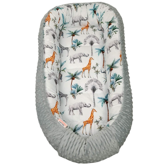 Safari theme toddler nest featuring giraffes and elephants on a soft grey and green background.