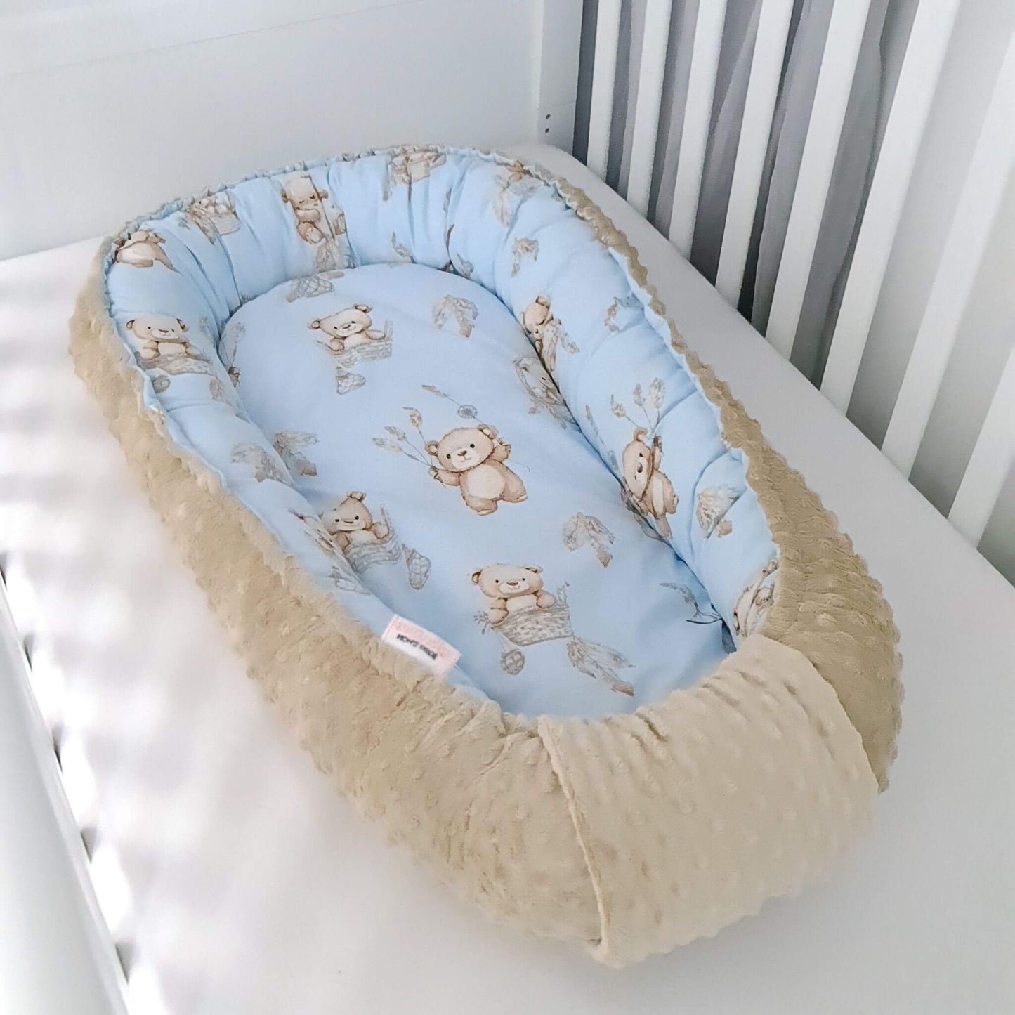 side of the baby lounger showcasing reversible design for newborn