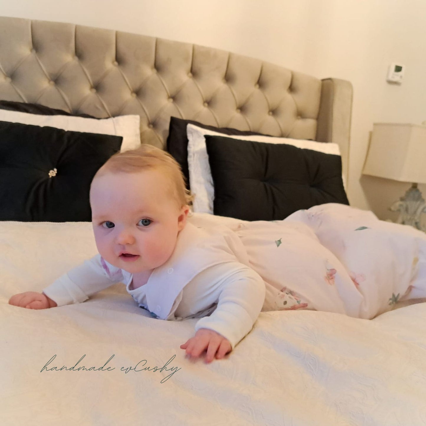 4 months old baby in a luxurious pink sleeping bag