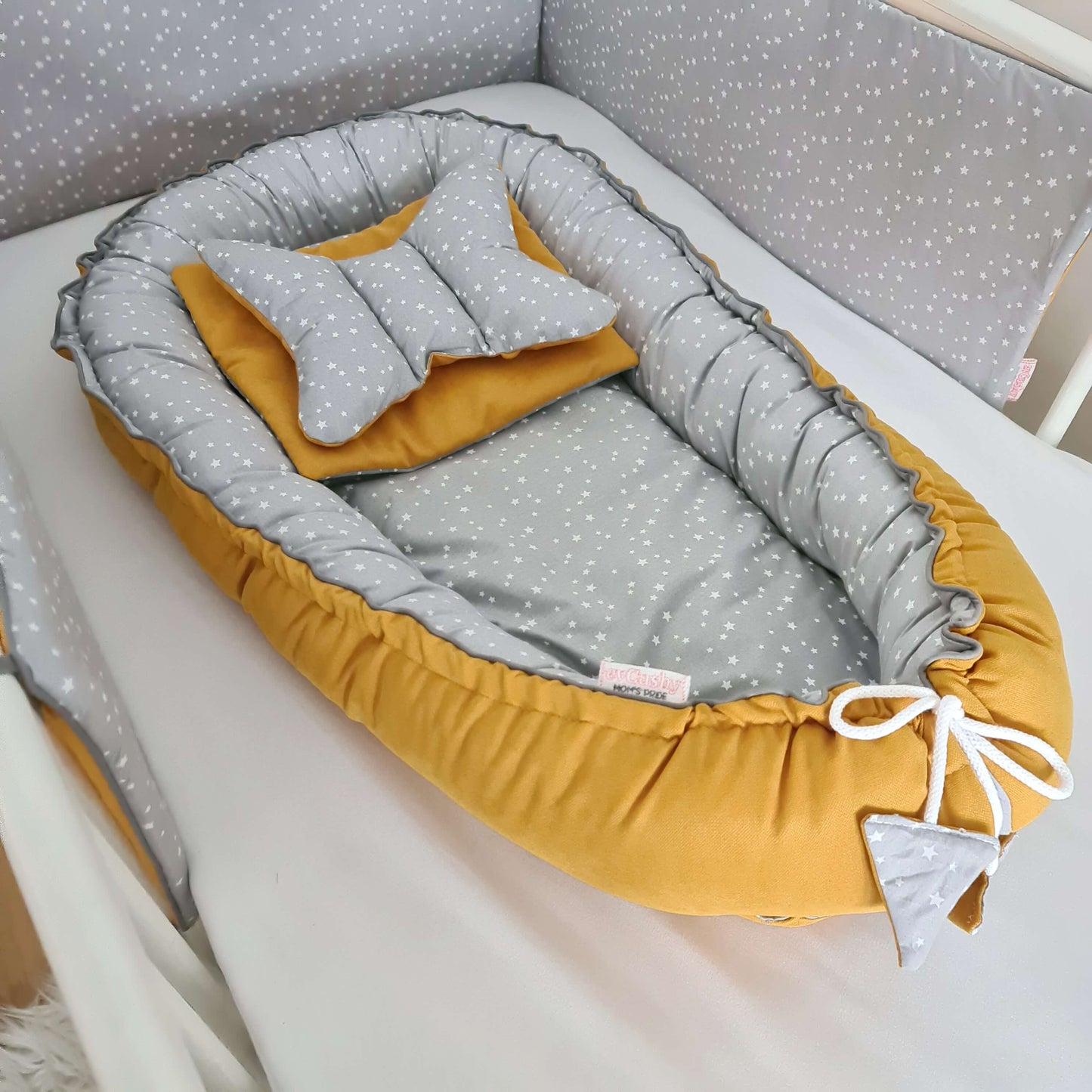 cosy place to settle to sleep for a new baby mustard and grey