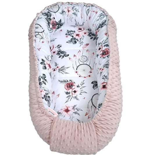 Baby nest with floral pattern and pink minky edge Evcushy pink baby nest sleep pod with soft liner for newborns to 9 months – cozy and portable baby bed.