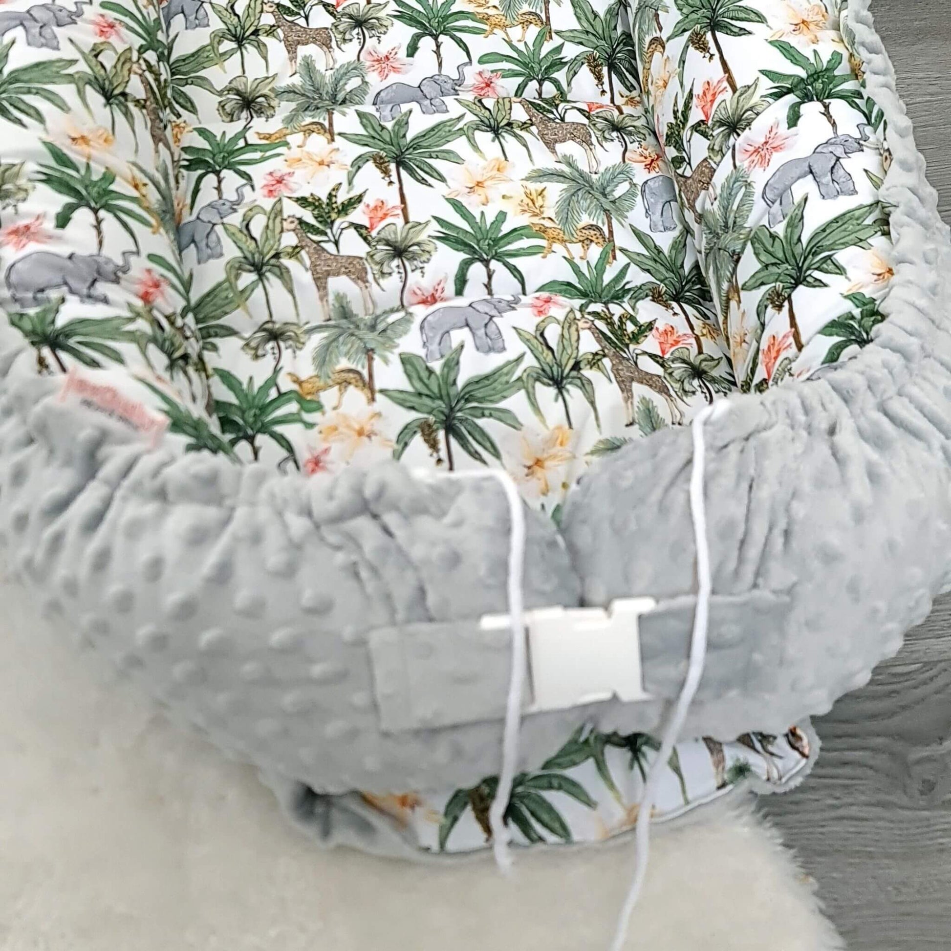 Soft baby lounger for toddlers in cotton and plush fabric with jungle theme and comfy padding.