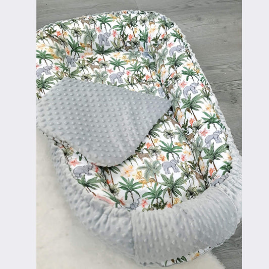 Toddler nest made of breathable cotton and cozy dimple plush, reversible with jungle print design.