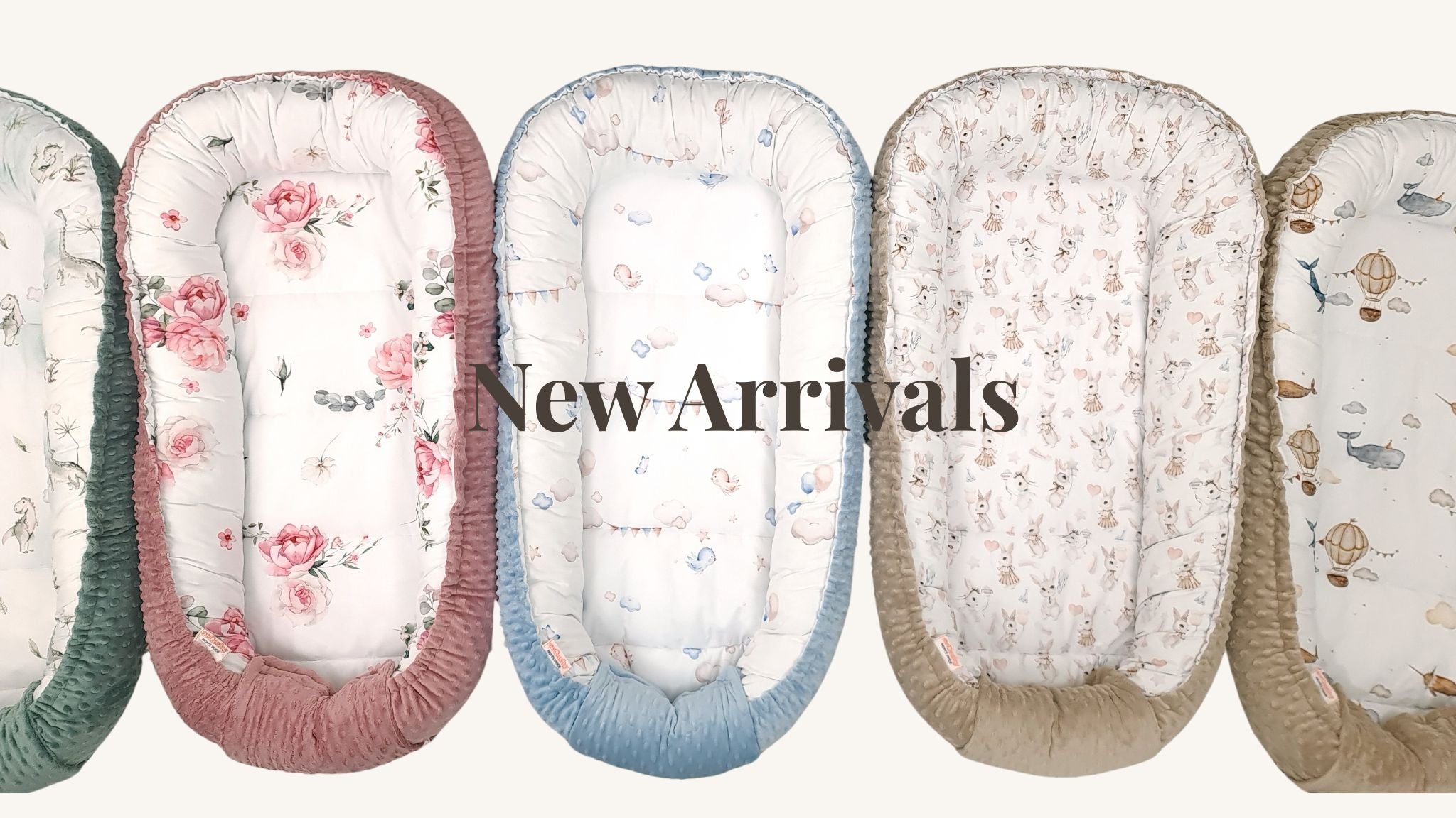 Row of baby loungers sleep pods nests with floral and animal patterns on a white background