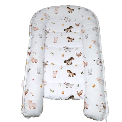 Baby lounger with animal pattern on a white background play mat and changing mat