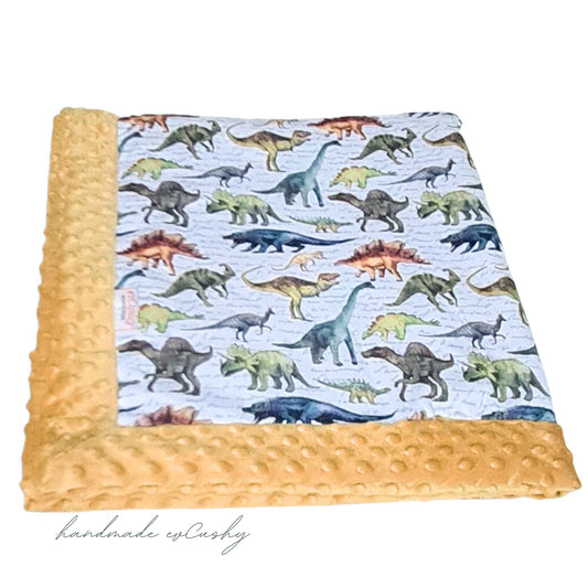 evcushy blanket for baby yellow mustard collors and dinosaurs pattern 100% cotton on one side and plush fleece on the reverse size 8-x100cm