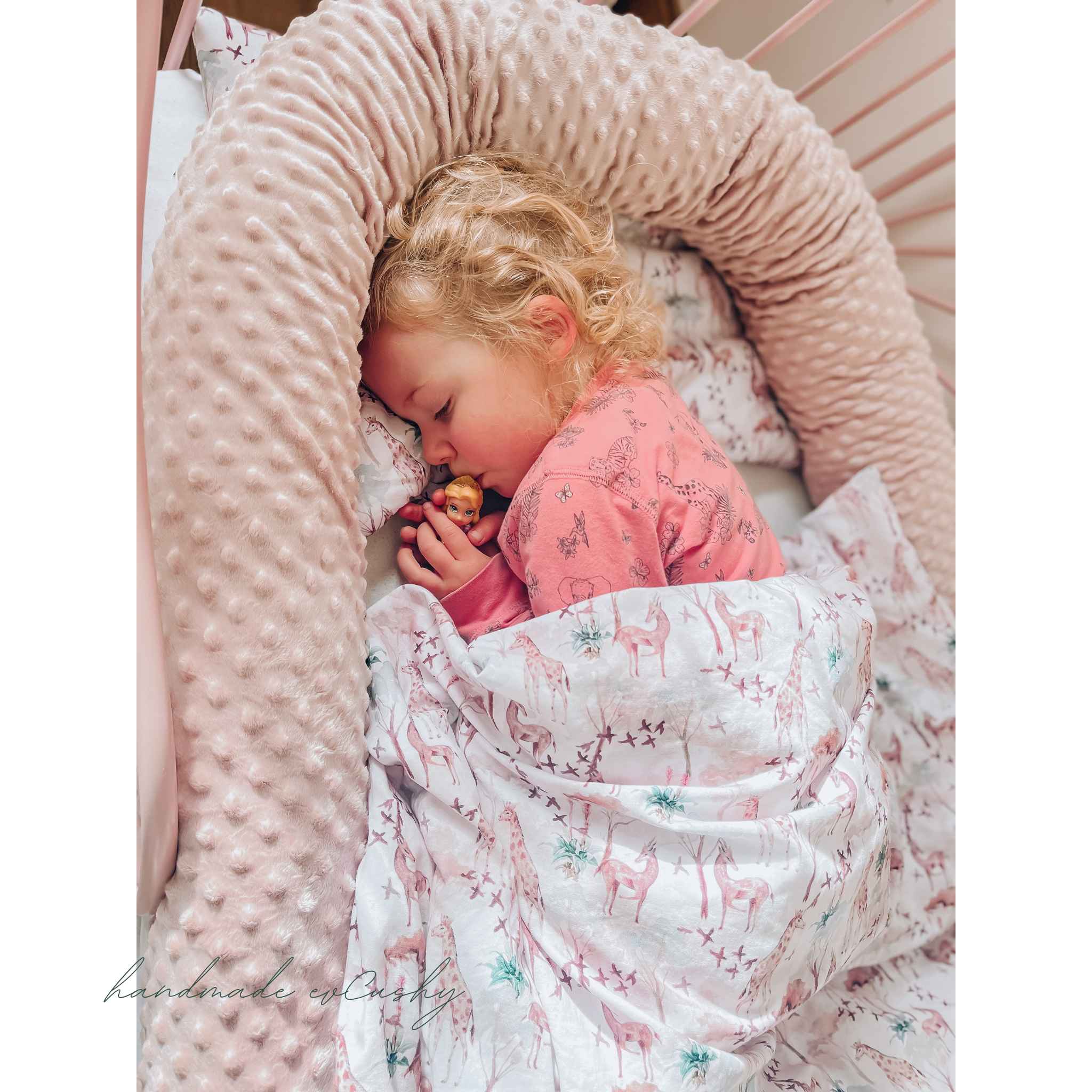 Baby sleeping on outlet pillow in cot