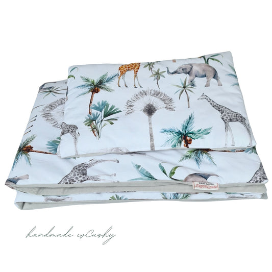 Image of a baby set with a charming grey and safari patterned cotton quilt and pillow, enhanced with luxuriously soft velvet for ultimate comfort."