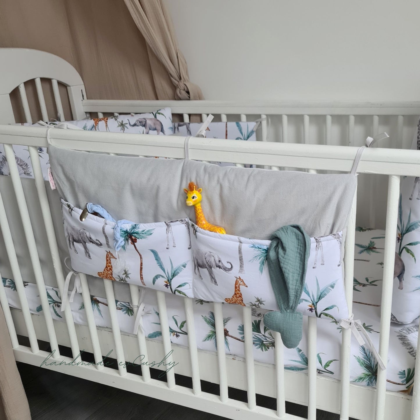 "Image: Safari Collection Cot Organizer – a versatile and stylish nursery accessory that attaches to cot bars, offering convenient storage for baby essentials."