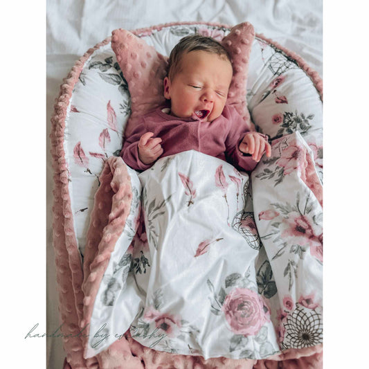 baby girl in a pink nest with cosy plush blanket evcushy