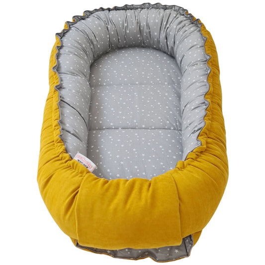 best sleep pod for newborn nest from 0-9 months yellow mustard colour on one side and grey with little garts on the reverse side