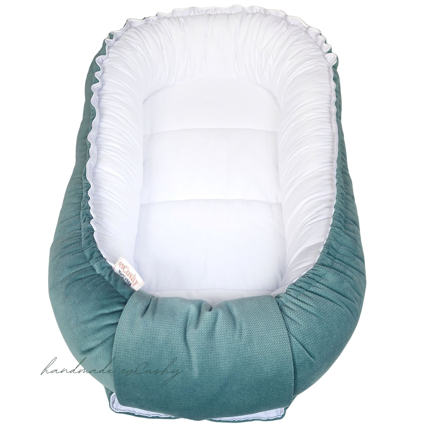 Luxurious white sateen cotton and mint green velvet Baby Nest Sleep Pod, designed for newborns to 7-9 months, certified safe materials, stylish and soothing.