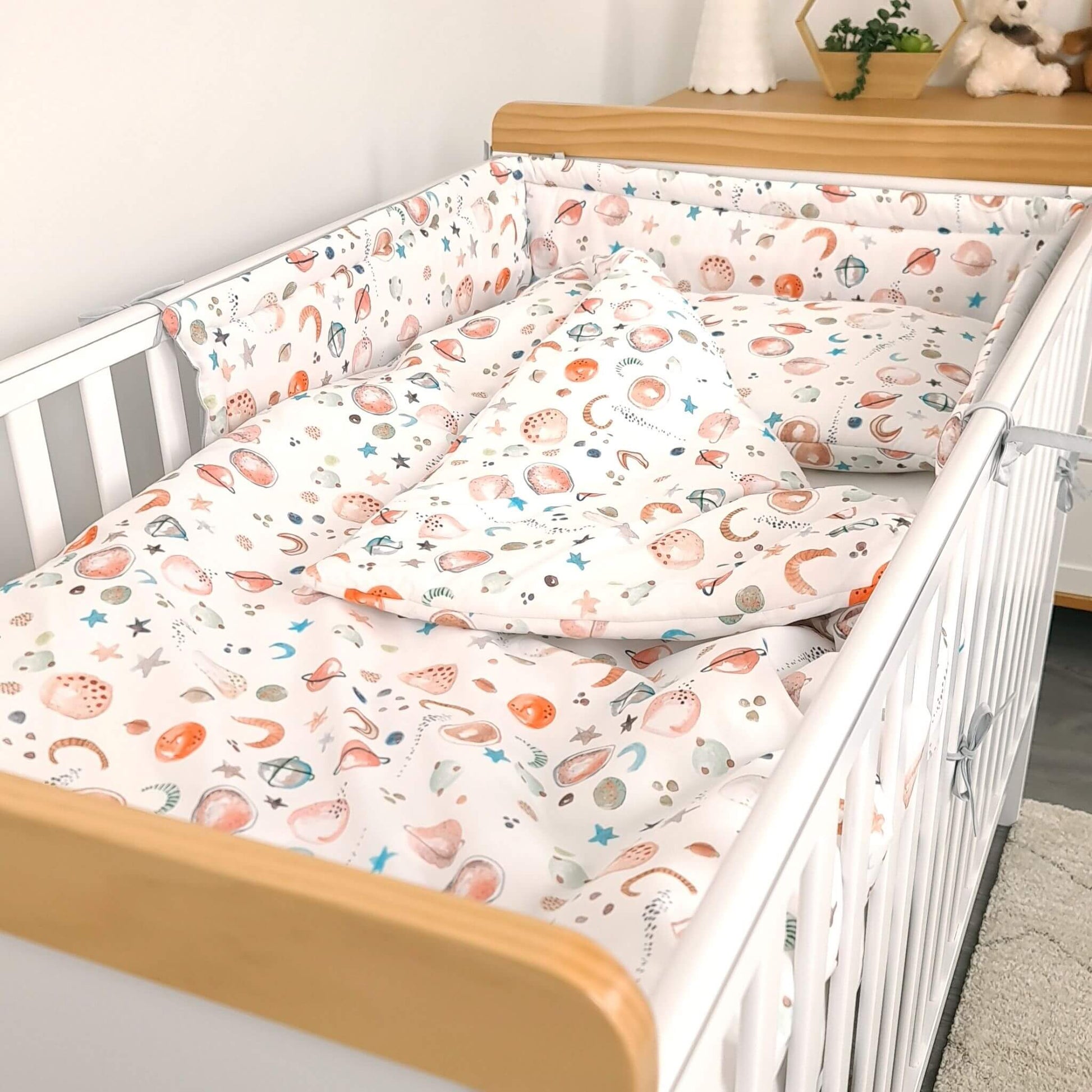 cot bed 70x140 with bedding quilt and pillow bumer with space theme stars moons planets unisex colours