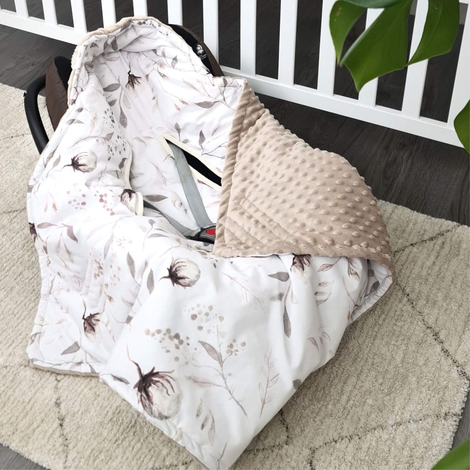 Handmade floral baby car seat cover with plush soft fleece lining, cosy and lightweight for newborns.