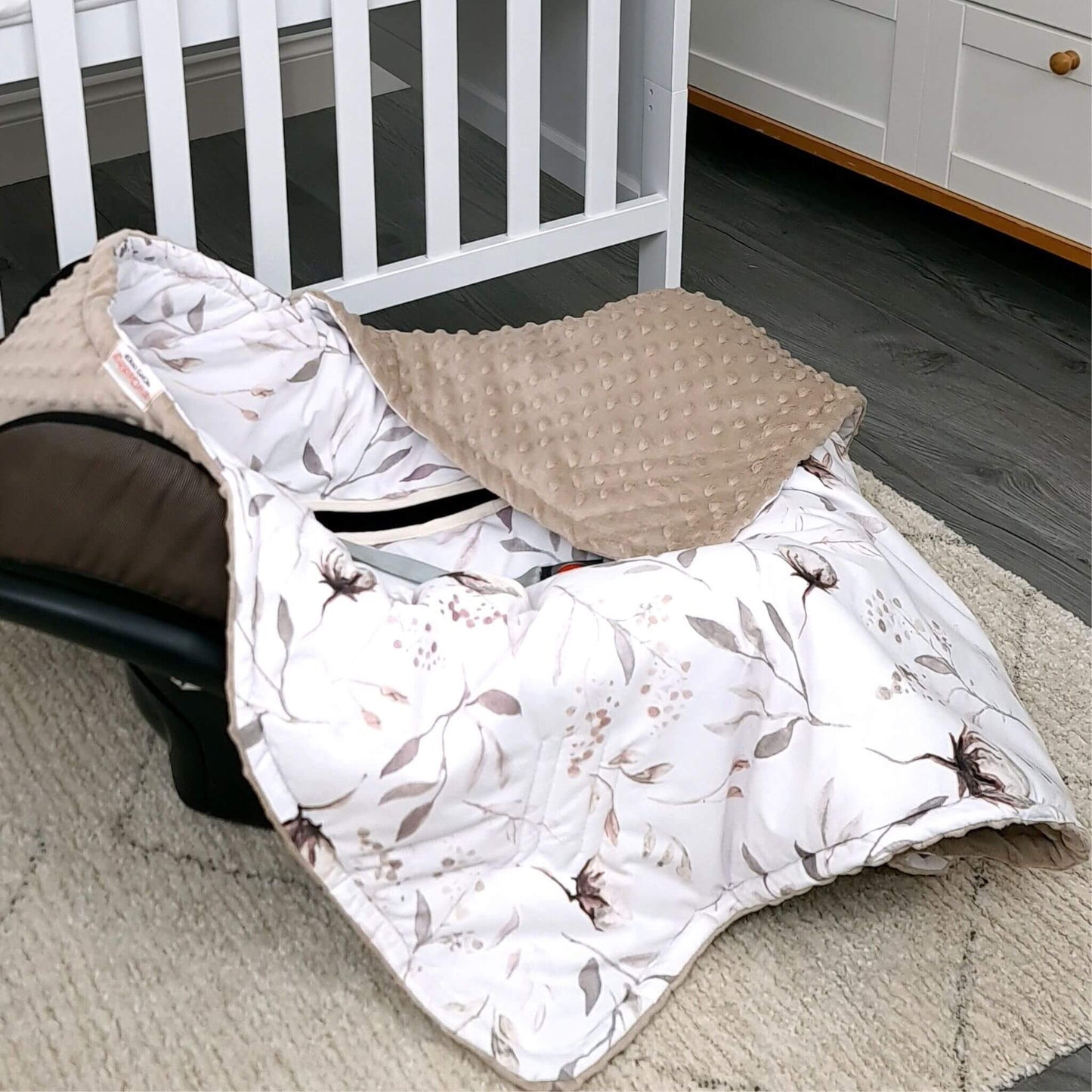 Baby wrapped in Cotton Blossom car seat blanket inside infant car seat, breathable cotton and soft plush lining.