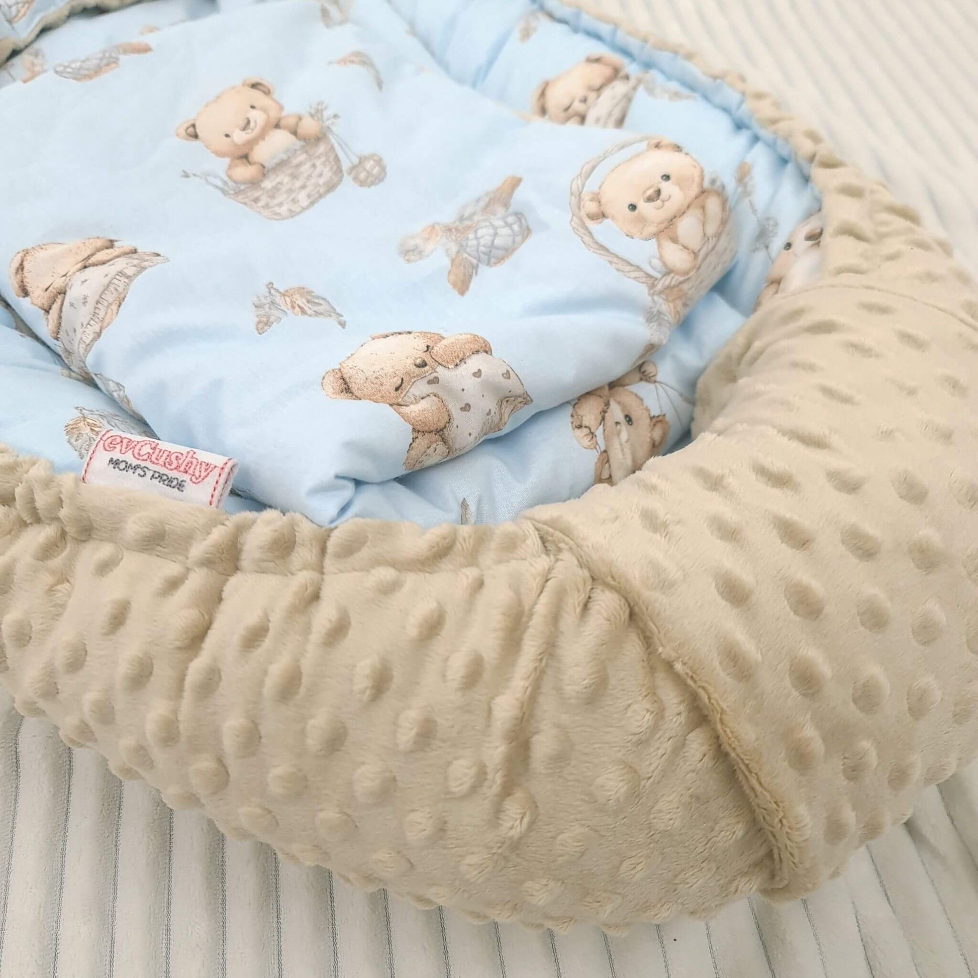 Close-up of beige teddy bear print cotton and beige minky fabric