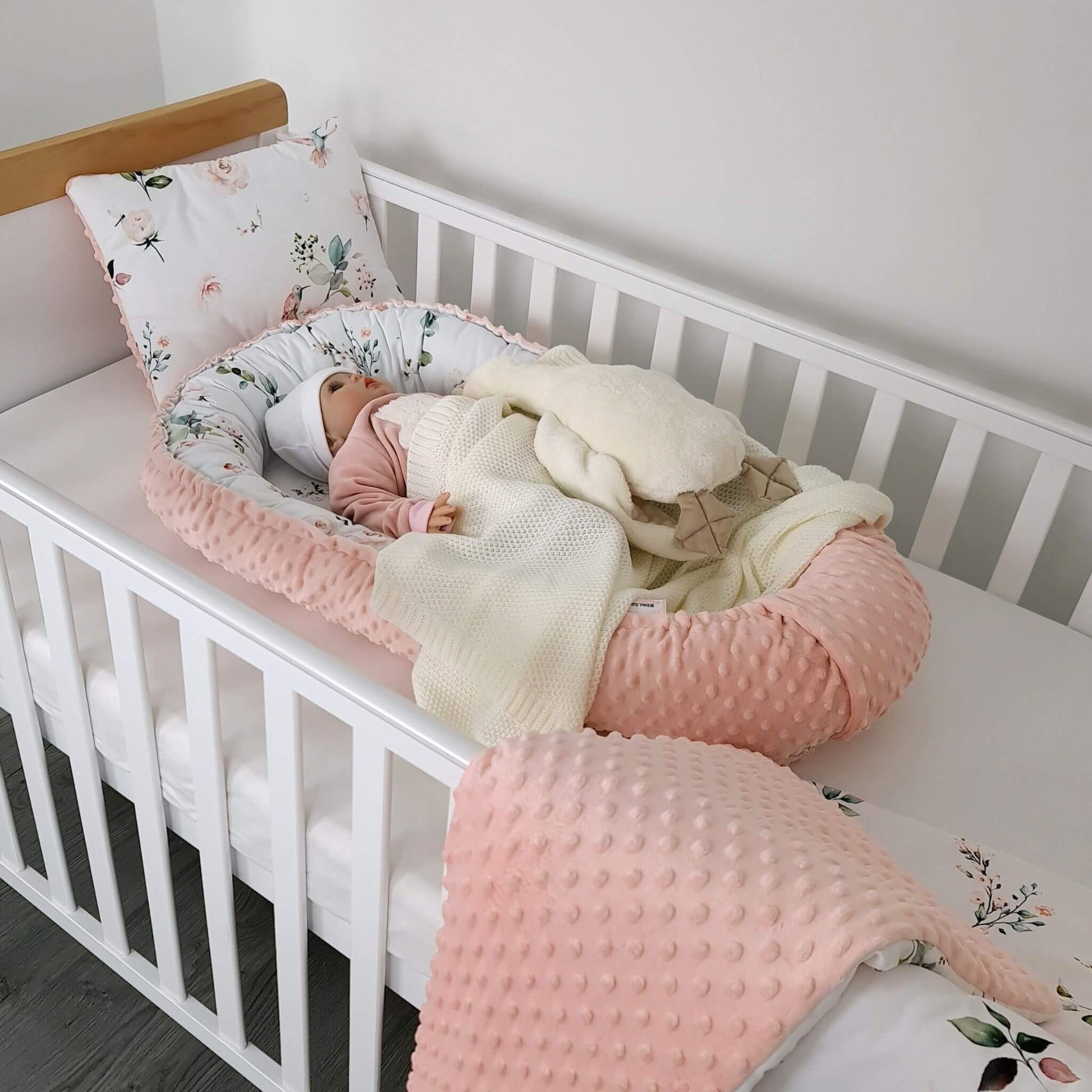 Lifestyle photo of floral breathable baby nest – cosy soothing sleeping accessory for newborns