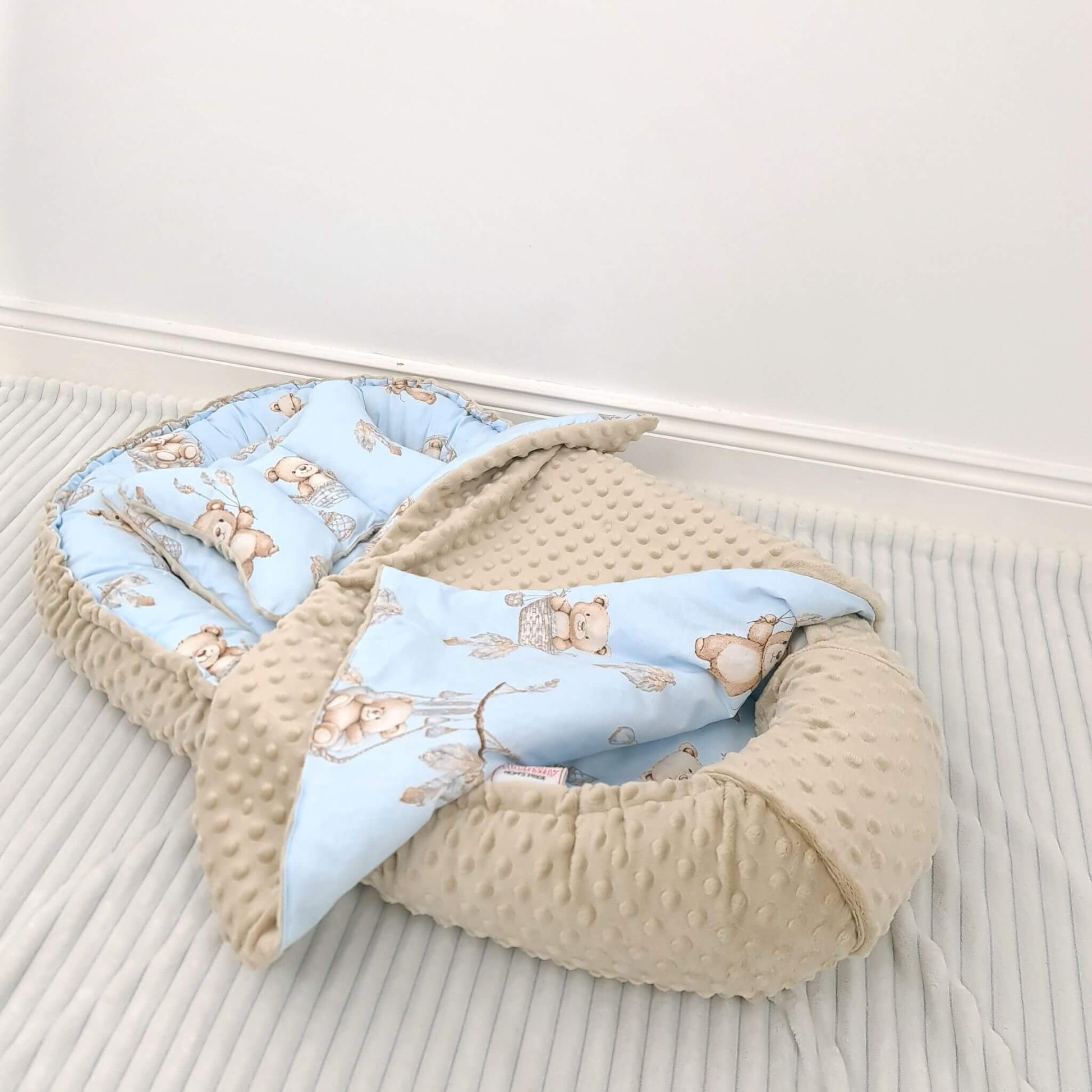 Evcushy Sweet Bears beige teddy on blue baby nest styled in nursery