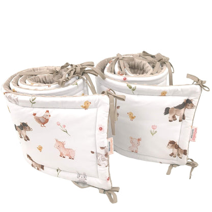 Close-up of Farm Friends baby cot bed bumper fabric and ties set of bumpers o cover the whole cot
