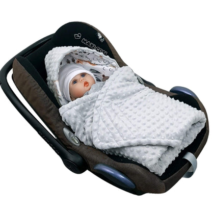 Newborn baby wrapped in Evcushy Forest Animal Friends car seat blanket with woodland animals design