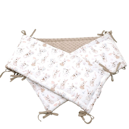 Close-up of retro bunny cotton fabric and ribbon bow details on cot bumper for baby girl