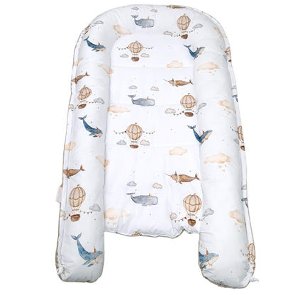 Top view of Mocha Mousse bottom baby nest with whale and balloon pattern play mat for toddler