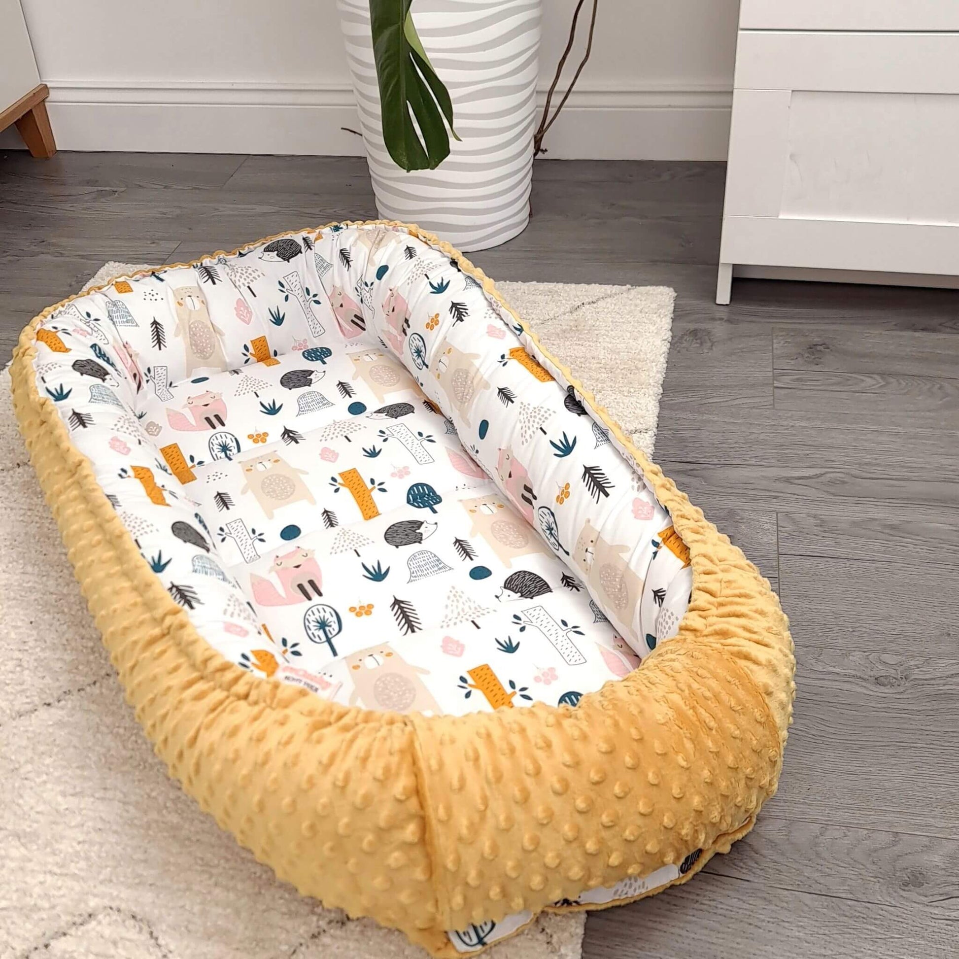 evcushy sleeping pod for transitioning baby to big cot forest pattern and mustard exterior