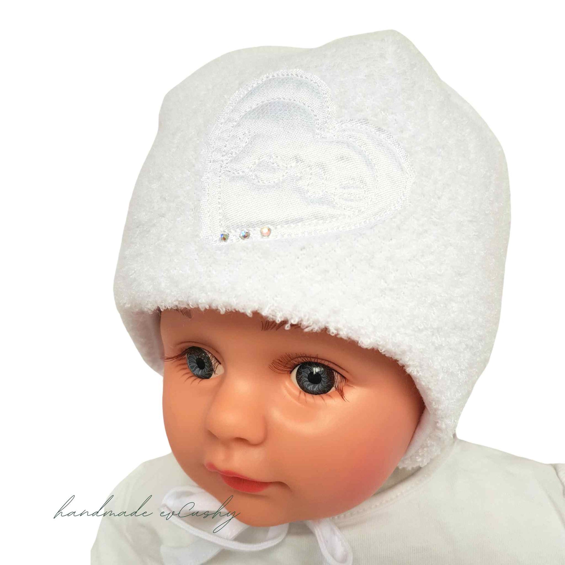 warm white hat for winter for baby girl bonnet like with heart embelishment on front
