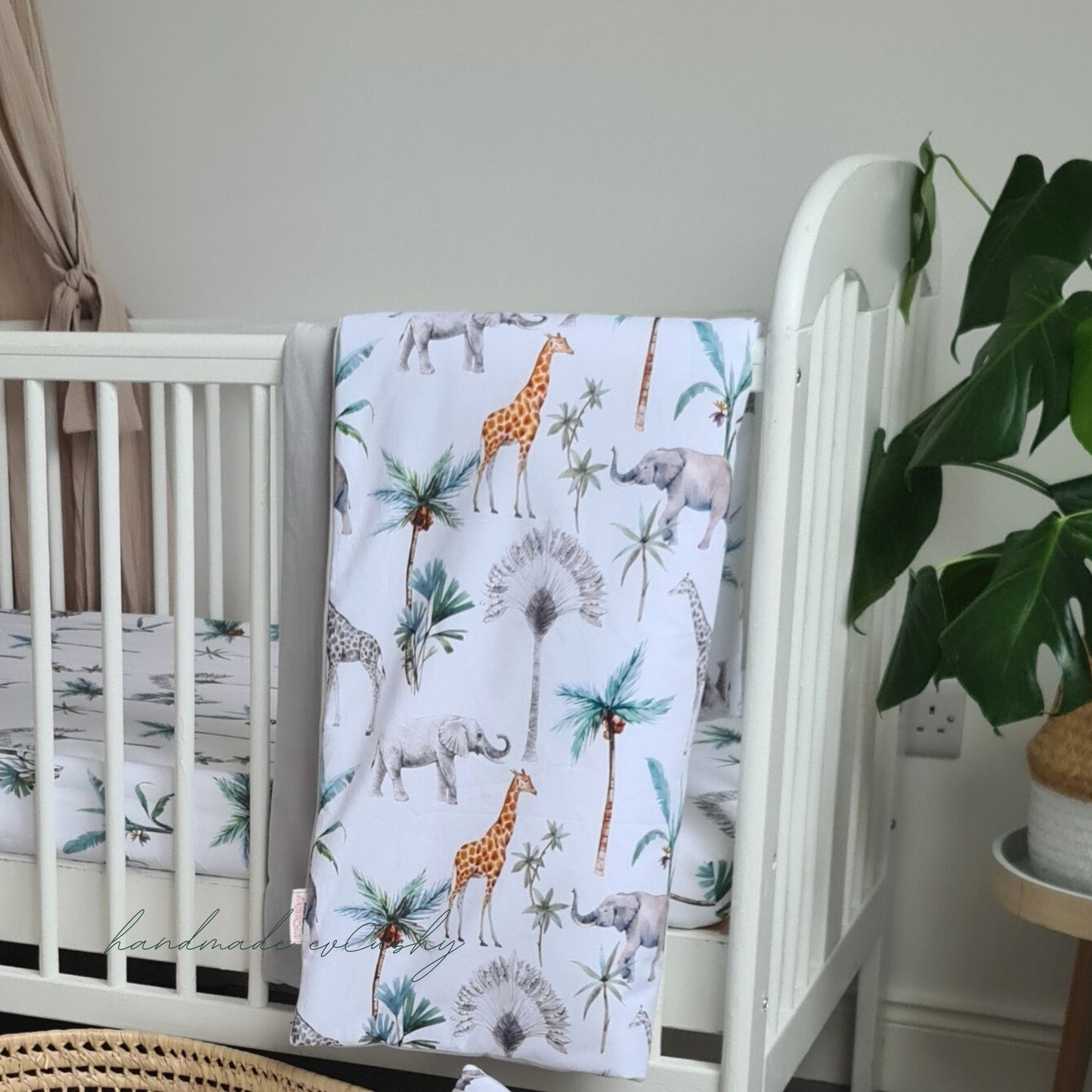 Image of a baby set with a charming grey and safari patterned cotton quilt and pillow, enhanced with luxuriously soft velvet for ultimate comfort."