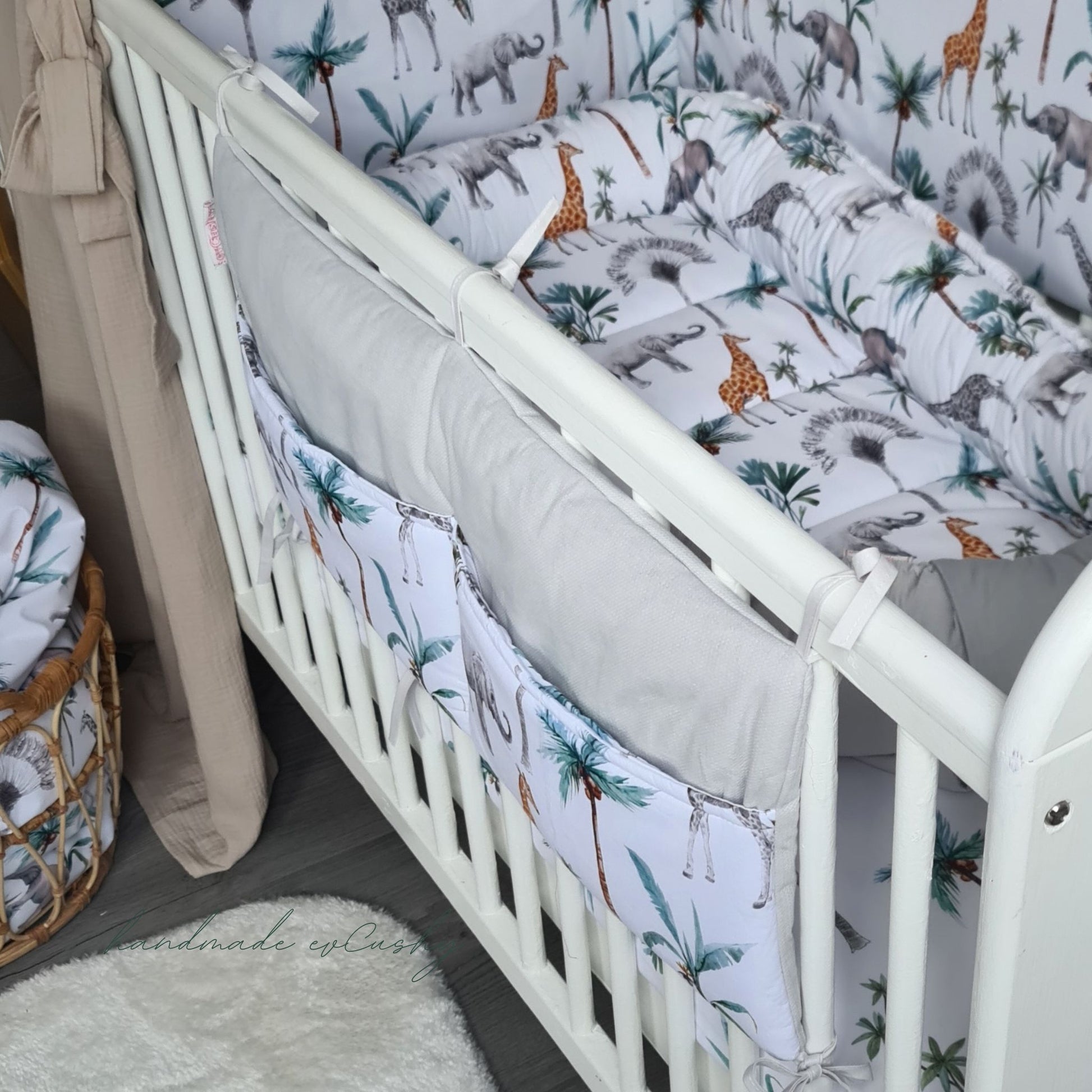 "Image: Safari Collection Cot Organizer – a versatile and stylish nursery accessory that attaches to cot bars, offering convenient storage for baby essentials. white grey and green"