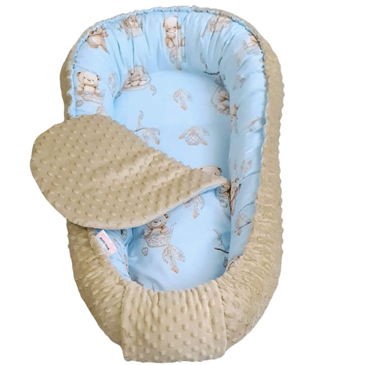 Baby nest with blue interior and beige exterior on a white background