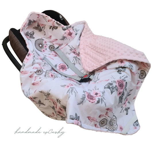 Image: A pink hooded blanket designed for newborn baby girls, perfectly sized to fit car seats.