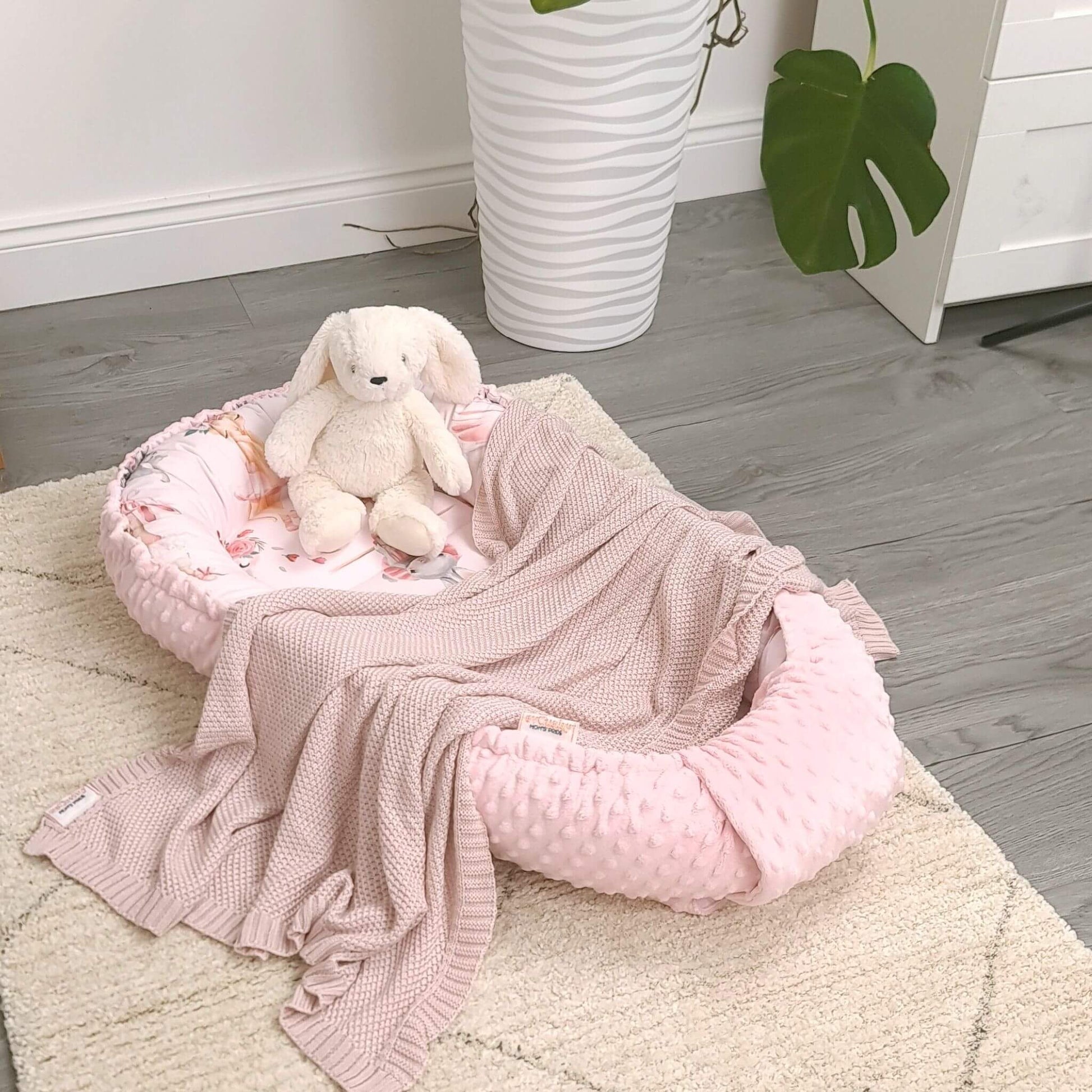 Portable pink baby nest pod ideal for travel