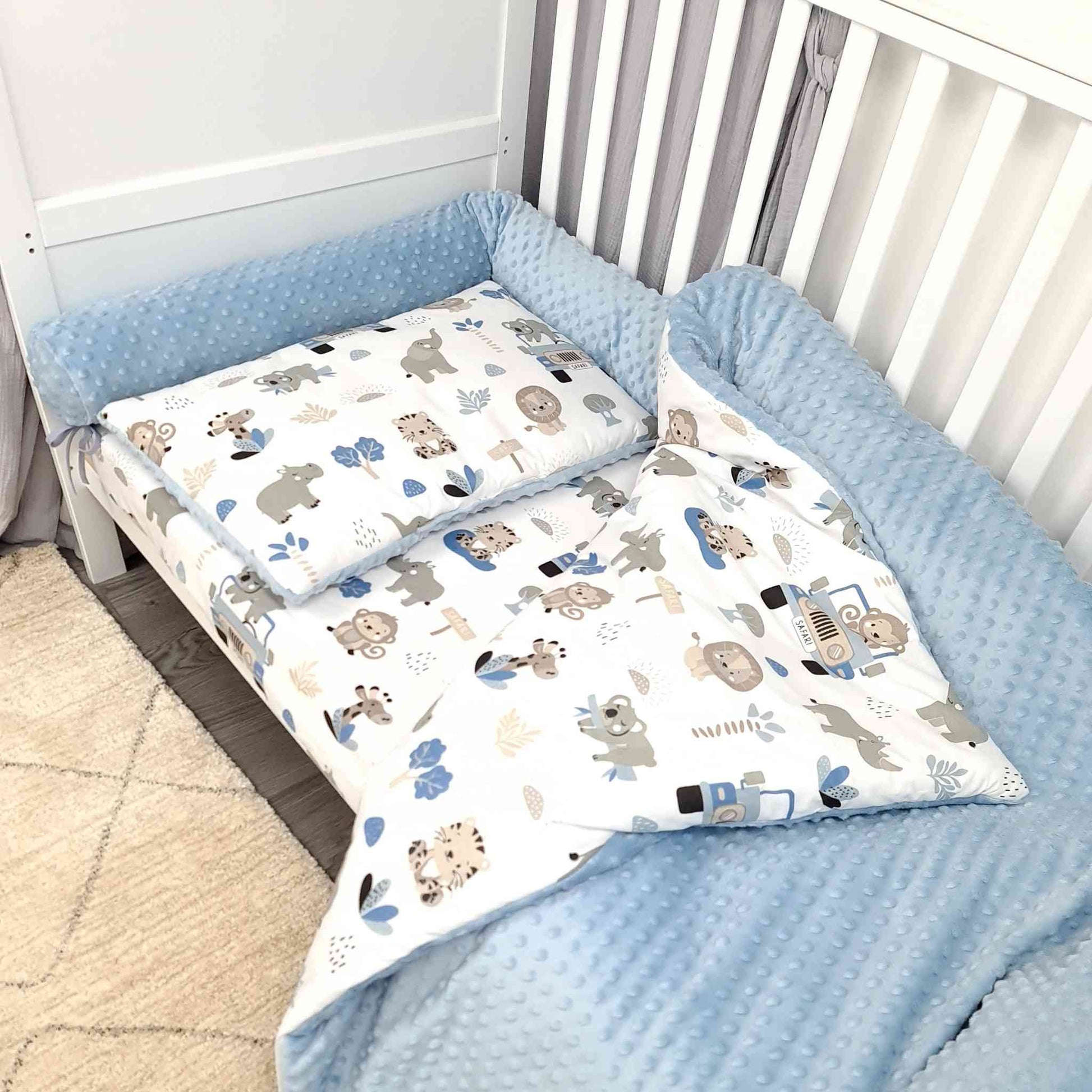 Baby duvet and pillow set made of soft cotton and plush blue fabric, featuring a safari pattern with animals and a jeep – cozy bedding for nurseries cot bumper and matching sheet