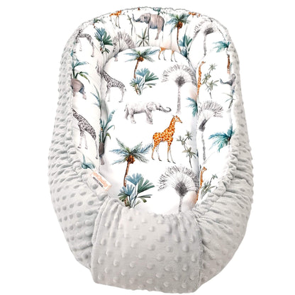 evCushy Baby Nest – Safari Adventure side featuring elephants, giraffes, and rhinos among palm trees