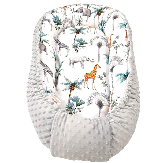 evCushy Baby Nest – Safari Adventure side featuring elephants, giraffes, and rhinos among palm trees