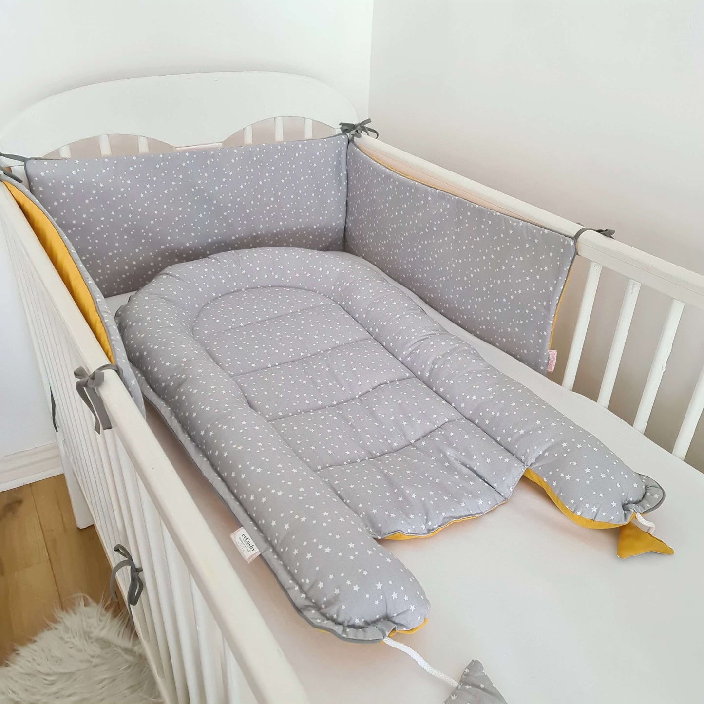baby nest sleep pod playing mat changing mat mustard and grey on the other side